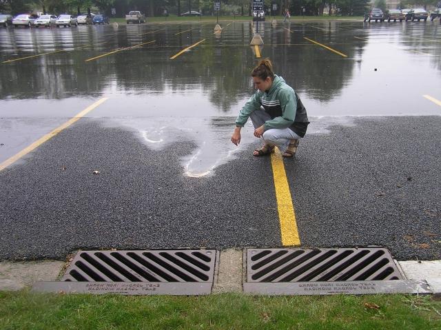 Girl standing near large puddle of water